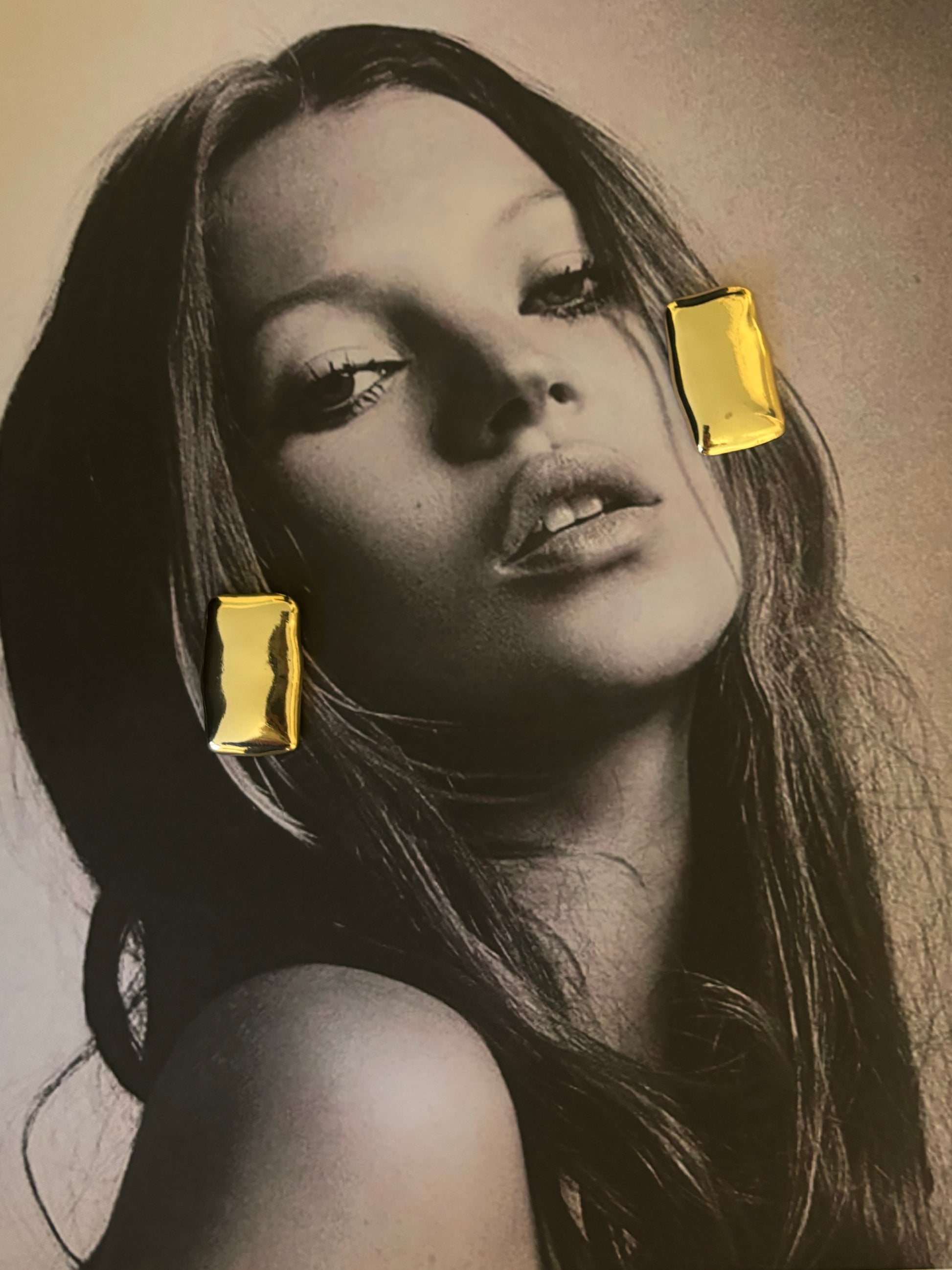 Captivating image of Harper Earrings from ÈRE featured on a magazine page, showcasing their elegance as gold statement earrings.