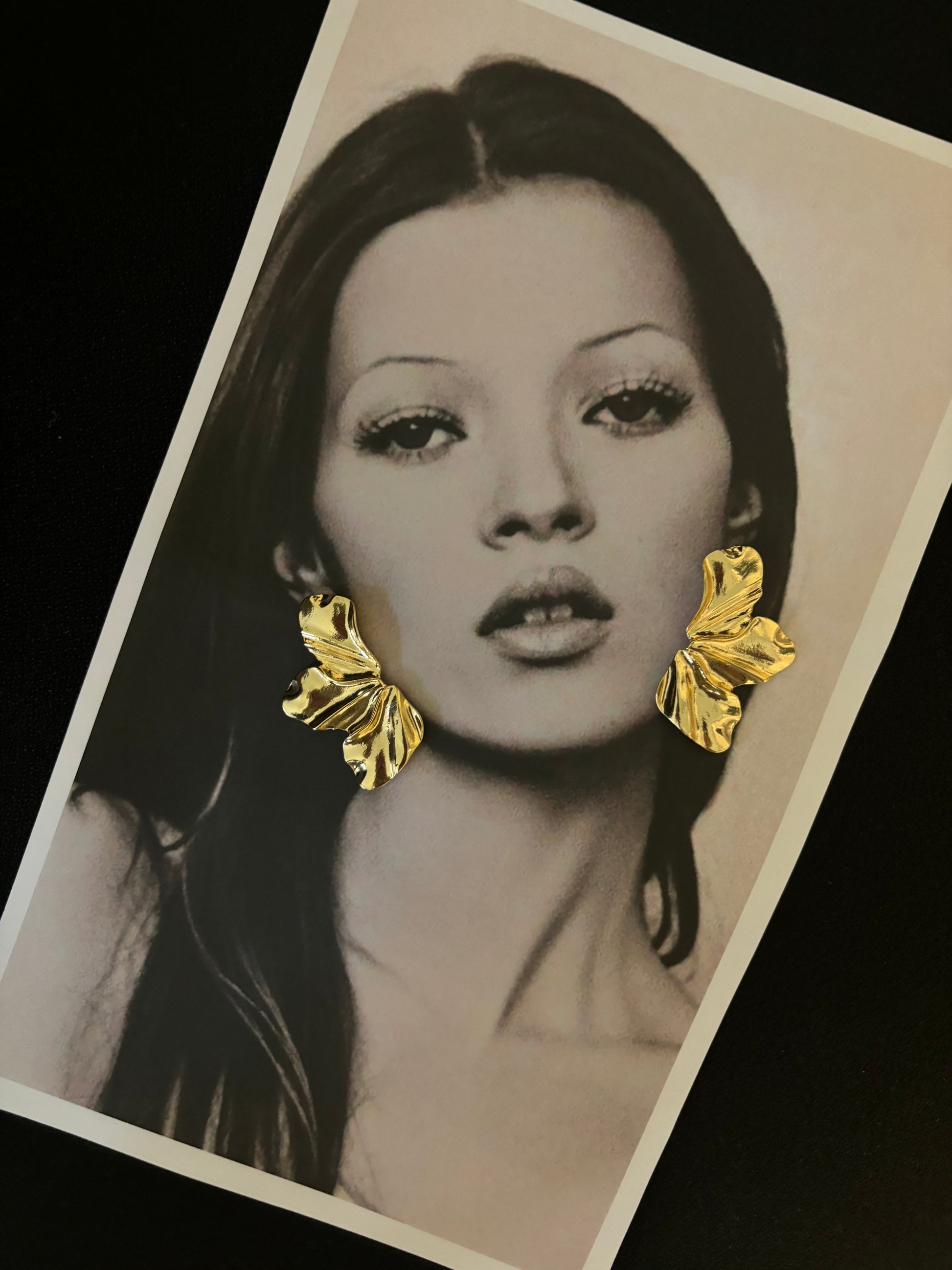 Model showcasing Faye Earrings by ÈRE, elegant floral statement earrings, enhancing a chic fashion look.