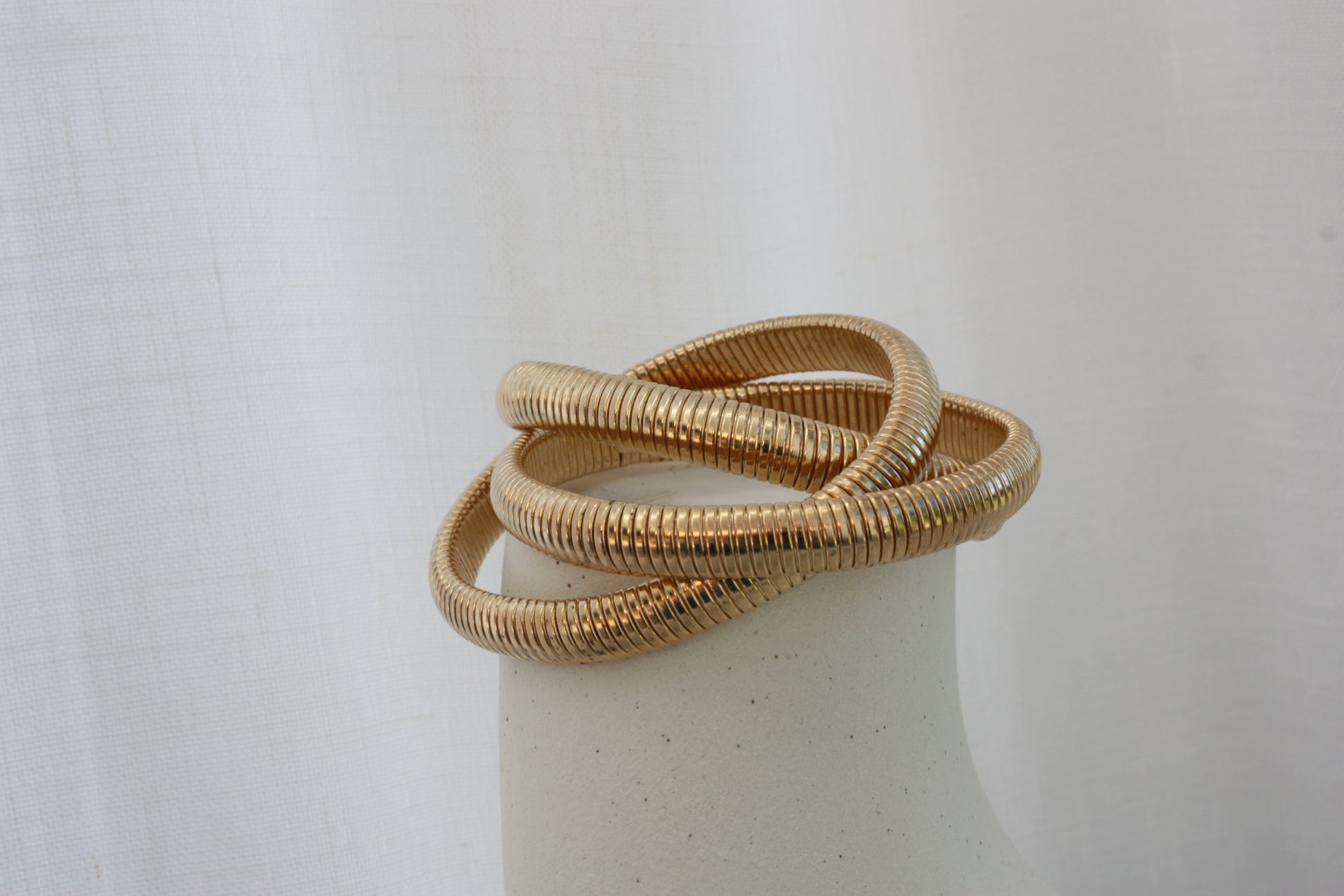 Stylish Rowe Bangle by ÈRE displayed on a minimalistic background, emphasising the stunning gold bangle's layered design.